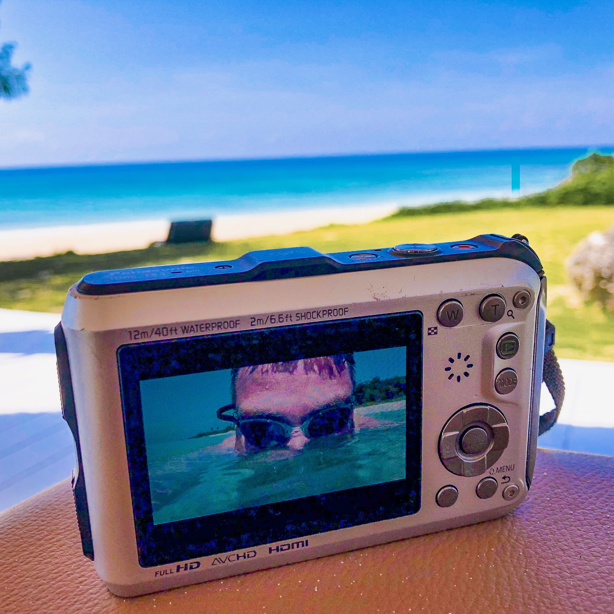 Photo of the camera showing me in the water on the screen.